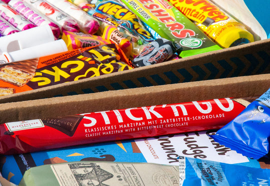 A pair of Penny Post gifts sitting side by side to each other. Featuring Retro Sweets & Chocolate gifts.